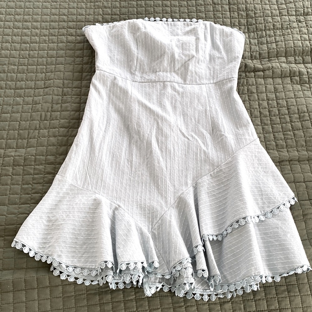 Baby blue w/ white lines. Circle detail. Strapless with adjustable tie back.